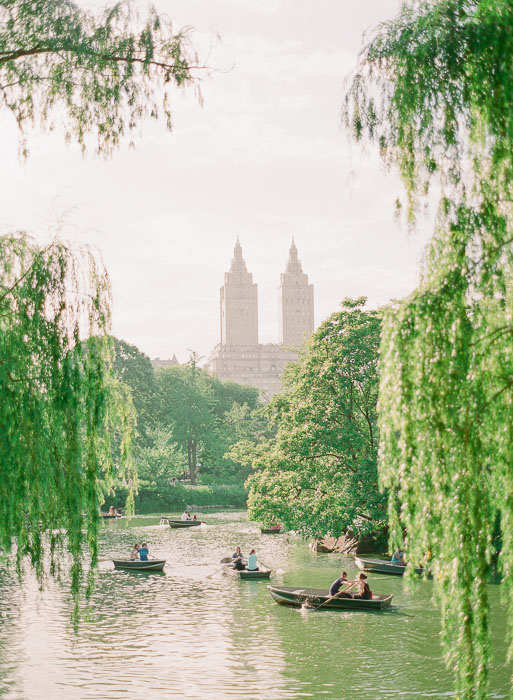 Boats out on the lake at Central Park during romantic engagement photos in NYC