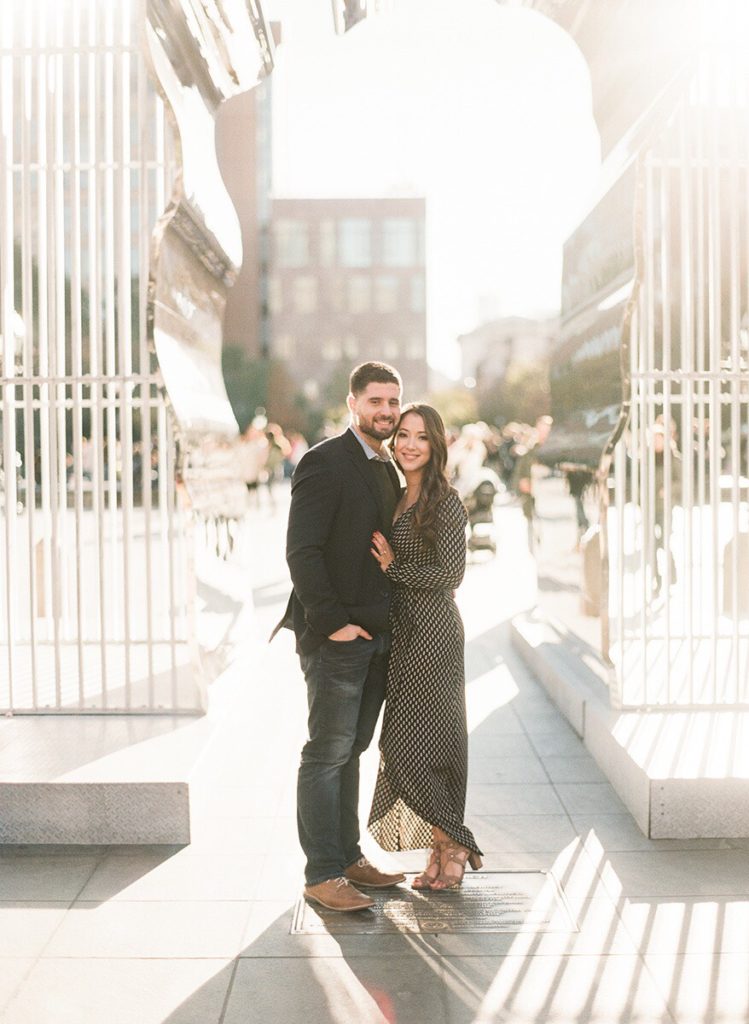 A special installation at the Washington Square Park Arch with a couple posing beneath it during NYC engagement pictures with You Look Lovely Photography