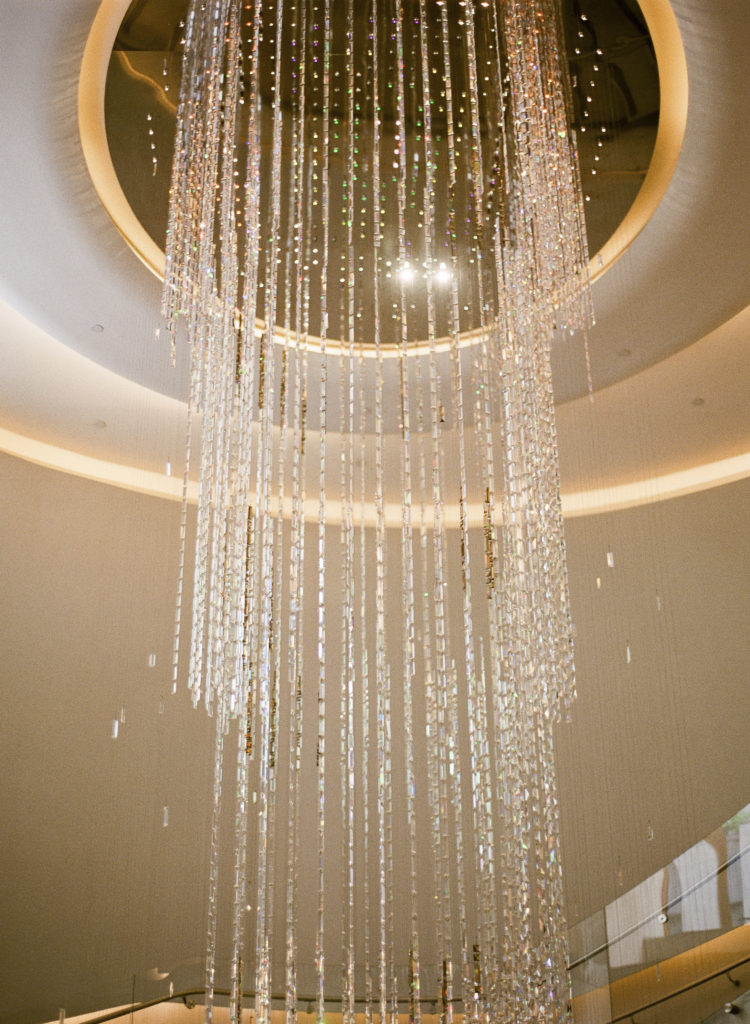 The cascading Swarovski crystal chandelier by Michael Hammers displayed in the Top of the Rock lobby photographed by You Look Lovely Photography