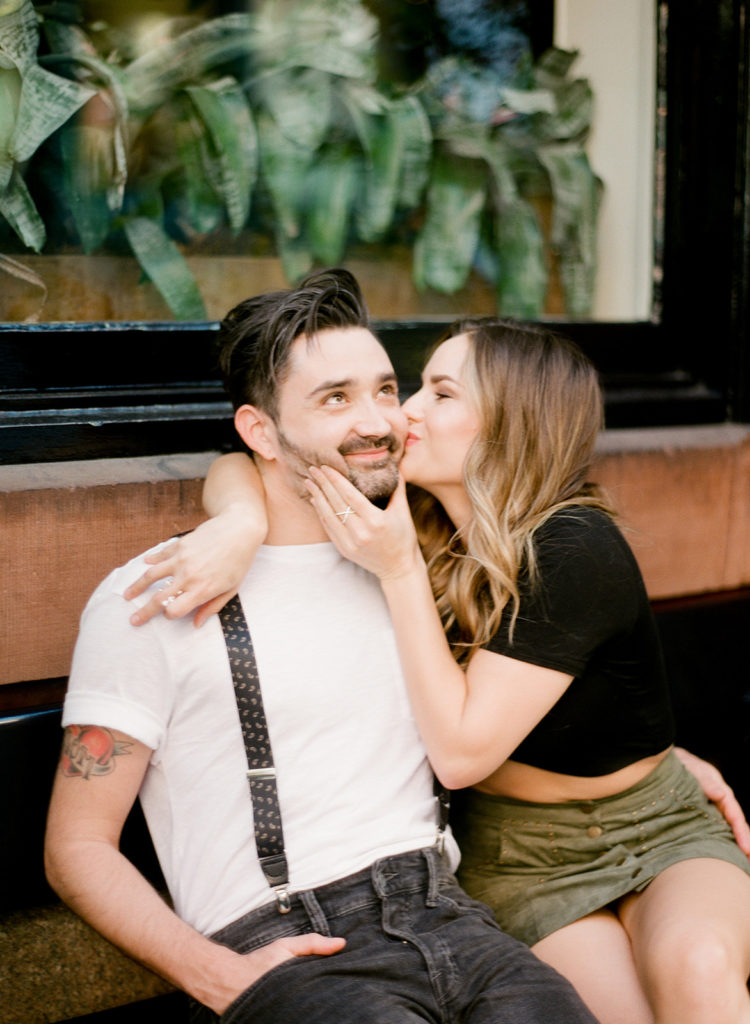 A stylish couple share an adorable moment during their SoHo NYC editorial engagement photos with You Look Lovely Photography