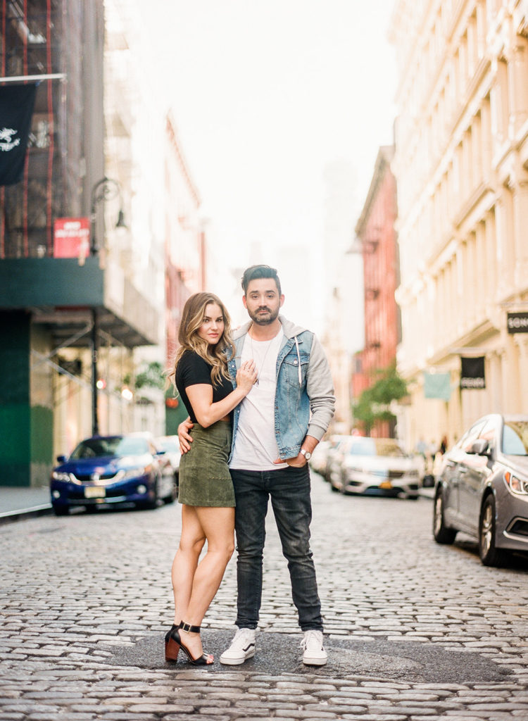 Couple standing on the cobblestone streets of Soho for their NYC editorial engagement photos with You Look Lovely Photography