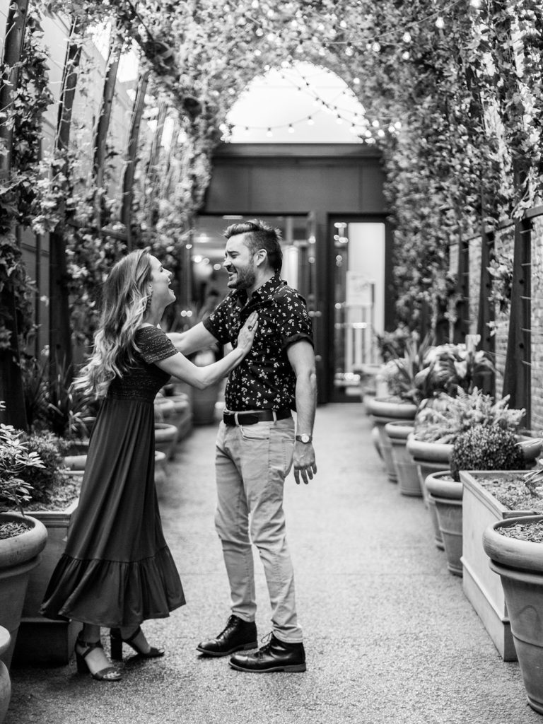 A candid capture of a playful couple laughing during their editorial engagement session with You Look Lovely Photography