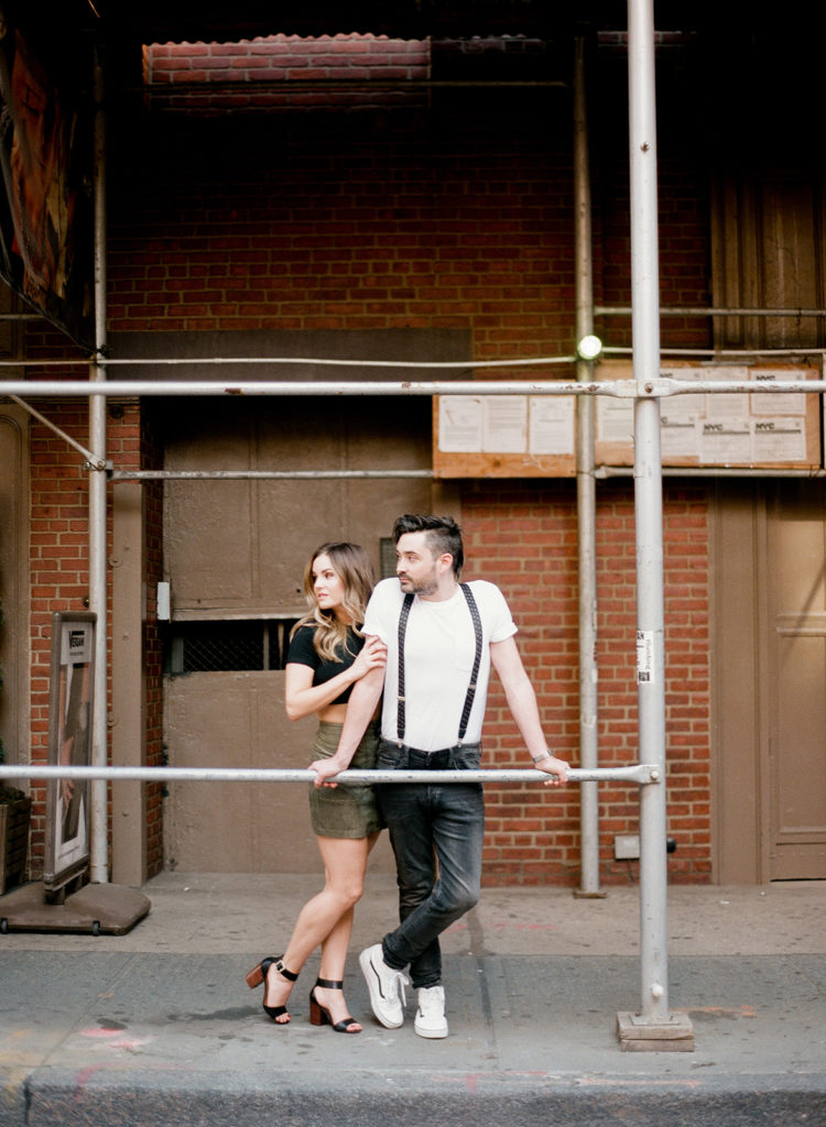Capturing the vibe of NYC streets using scaffolding as framing during an Editorial engagement photo session with You Look Lovely Photography