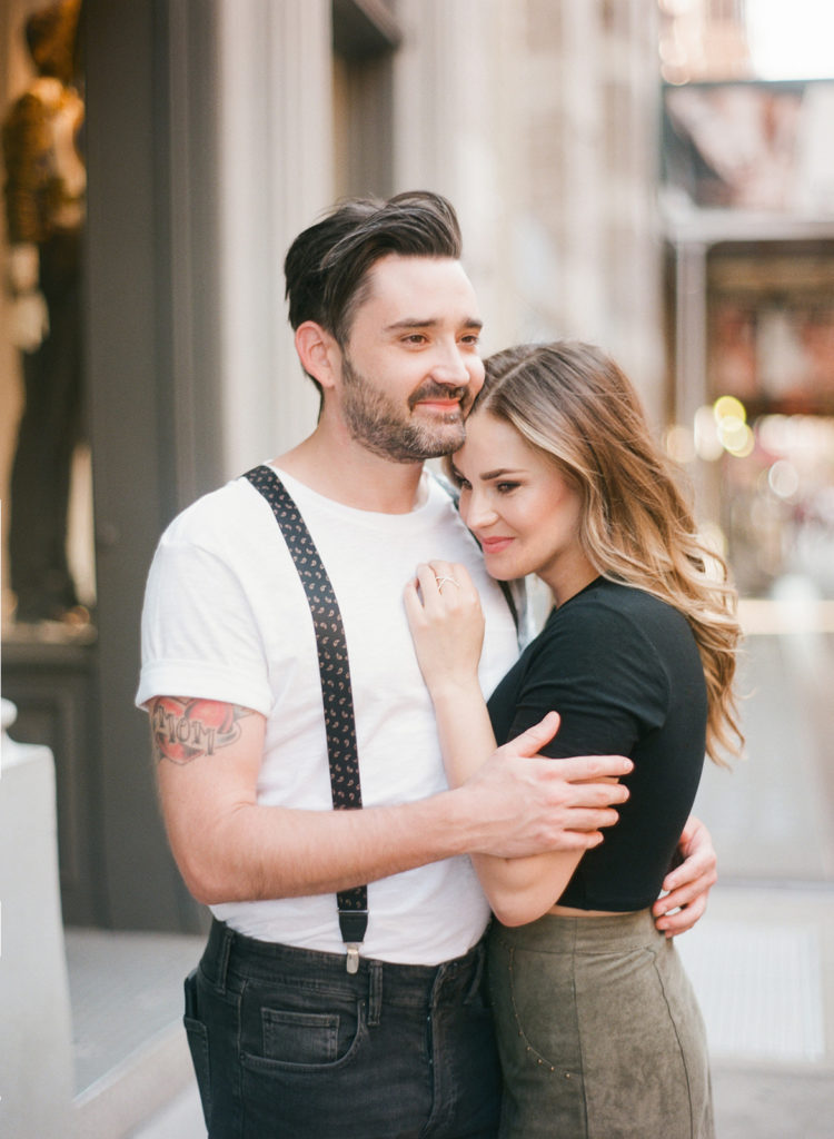 A couple embracing on the stylish streets of Soho NYC during their engagement session with You Look Lovely Photography