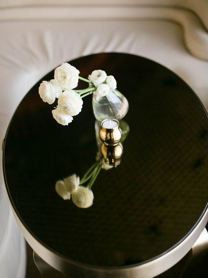 An image of a mirrored cocktail table with white ranunculuses at The Standard NYC photographed by You Look Lovely Photography