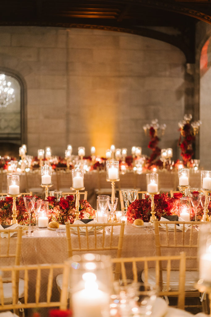 A candlelit reception with red roses for a wedding day at The Hempstead House in NY photographed by You Look Lovely Photography