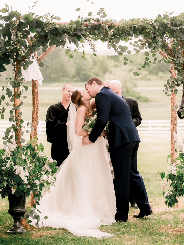 Couple sharing their first kiss as husband and wife photographed by You Look Lovely Photography