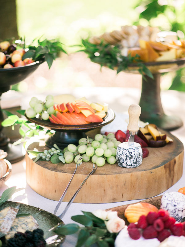 An array of fruit and cheese during a cocktail hour at a private estate wedding in Vermont photographed by You Look Lovely Photography