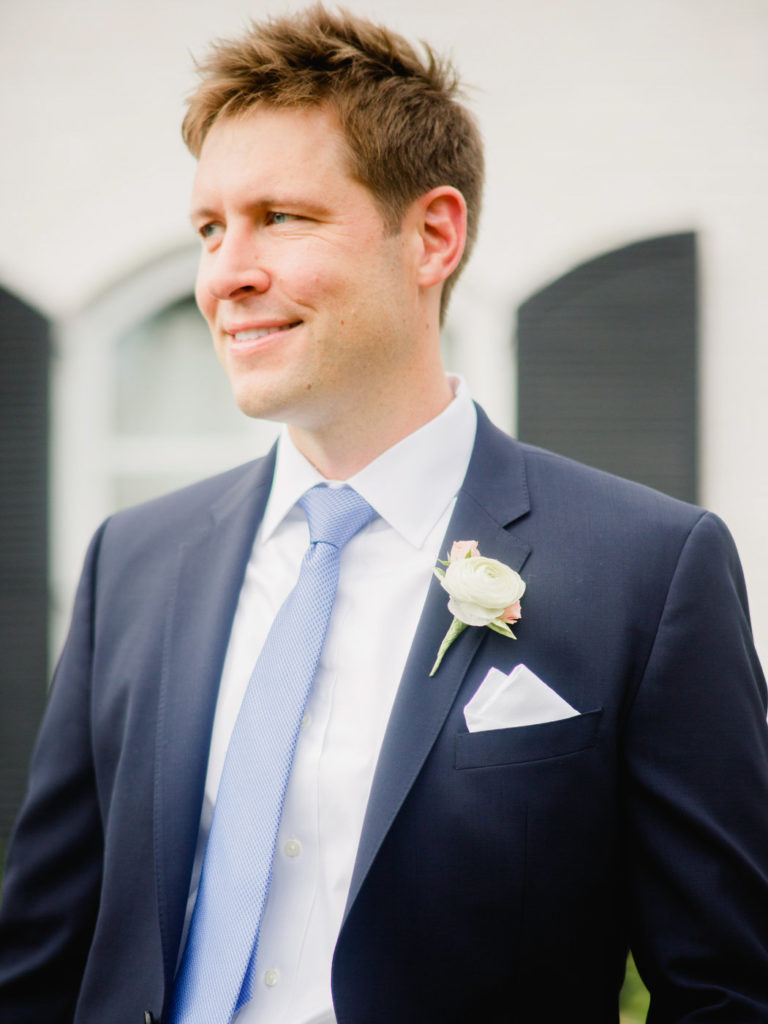A portrait of a groom in a blue suit at an intimate private estate wedding in Princeton, NJ photographed by You Look Lovely Photography