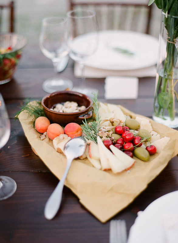 An array of fruits, cheese, and olive on a wedding reception dinner table photographed by You Look Lovely Photography