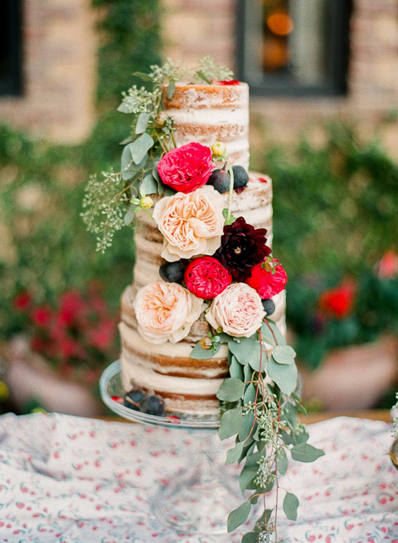 A floral covered naked cake photographed by You Look Lovely Photography