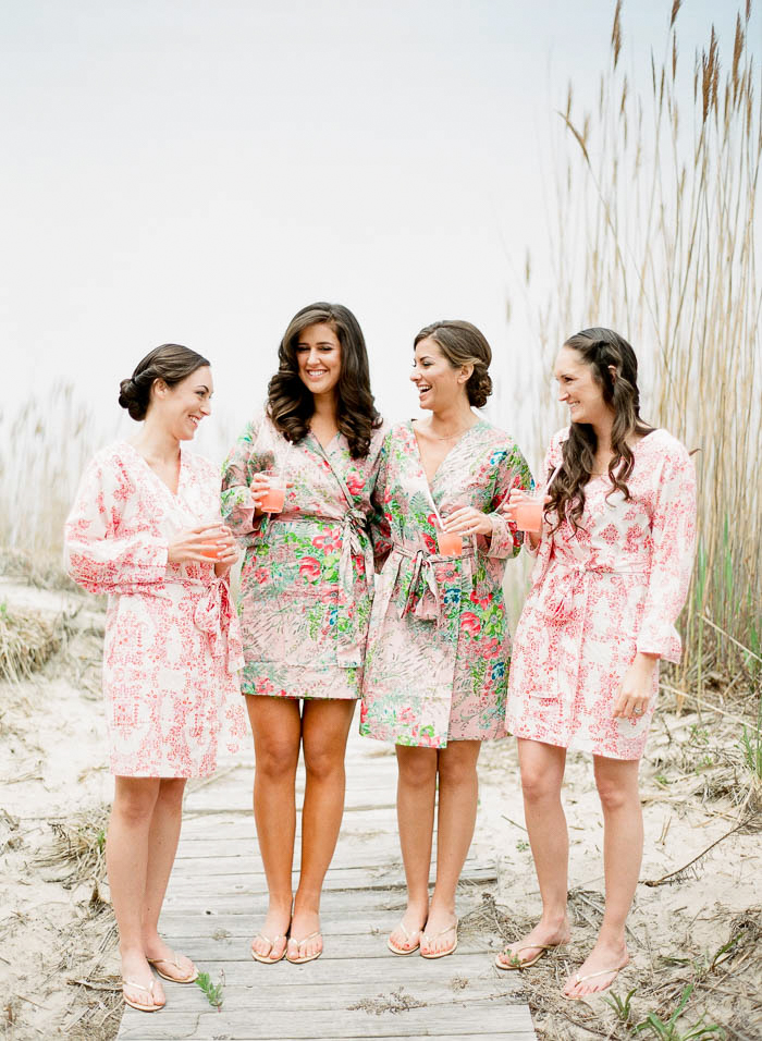 Bridesmaids wearing robes and holding champagne for a Hamptons wedding photographed by You Look Lovely Photography